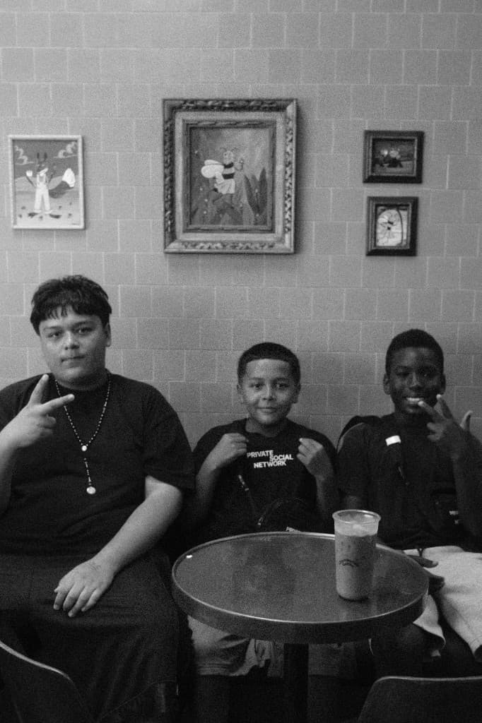 Three young men sitting together at a table.